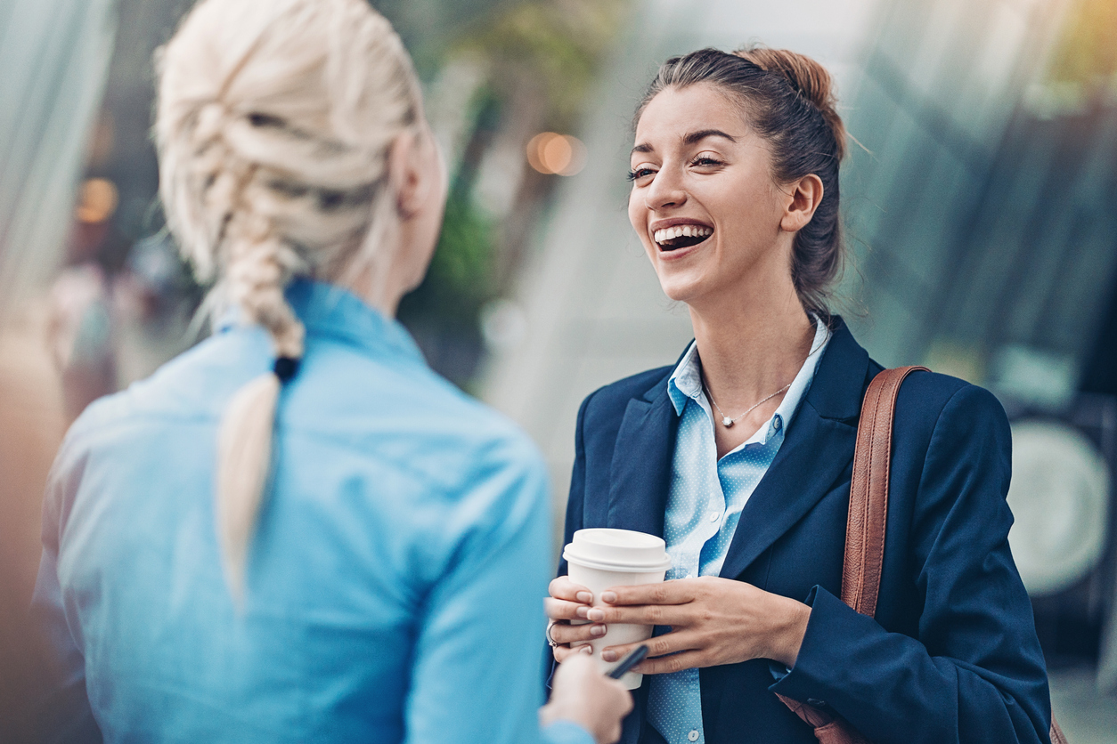 Businesswomen talking outside the office building